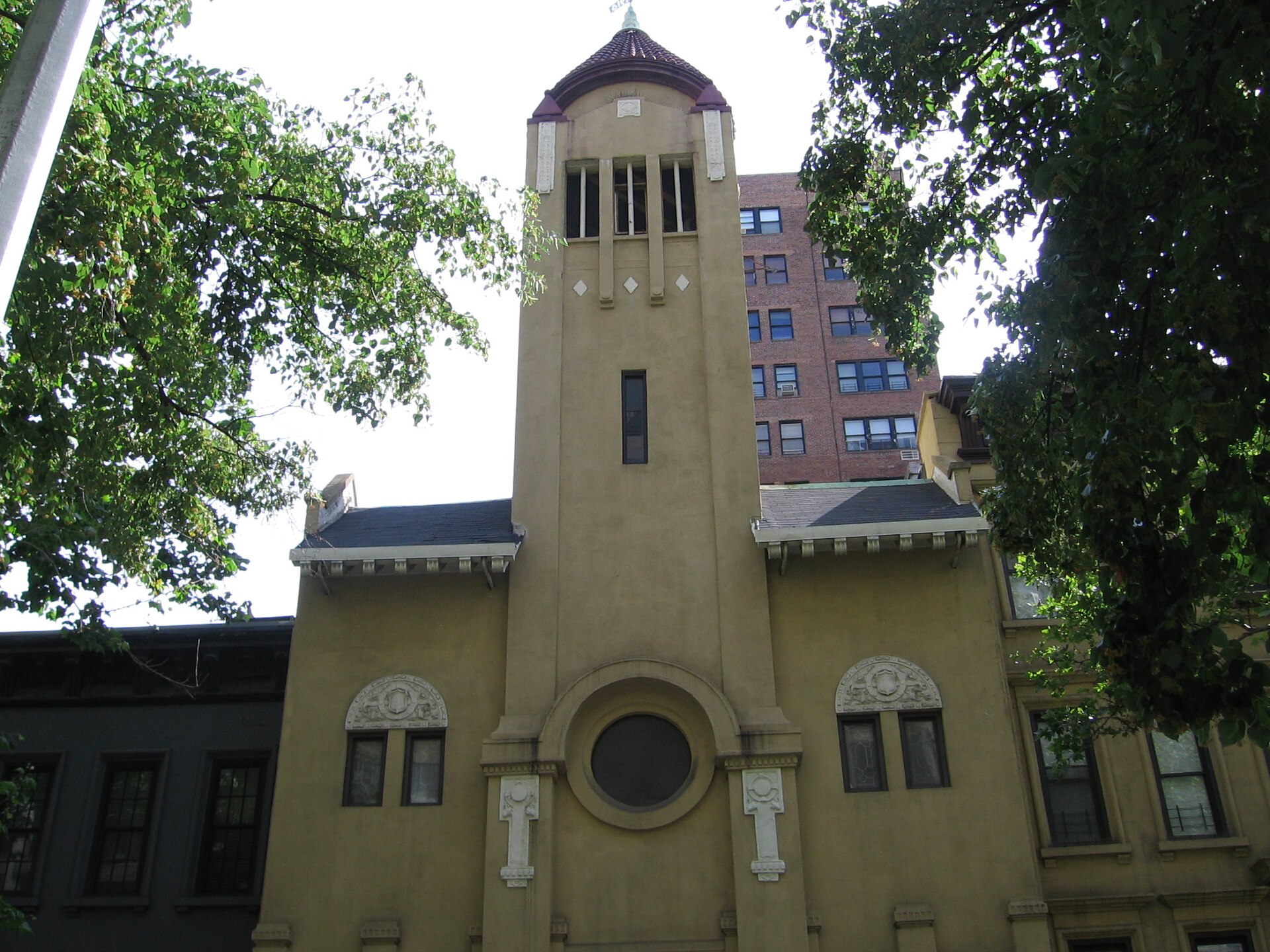 The tower and round window of the church at 346 East 69th Street.